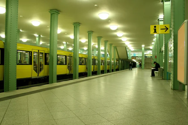 Man sitting at lonely underground station — Stock Photo, Image
