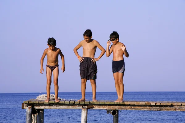 Boys on pier — Stock Photo, Image