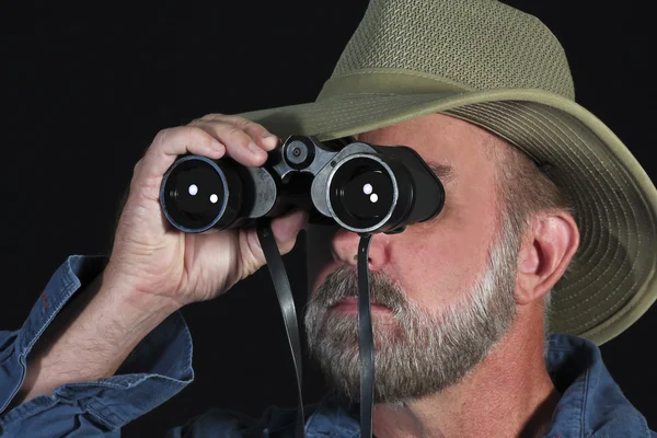 stock image A Man in a Safari Hat Looks Through Binoculars