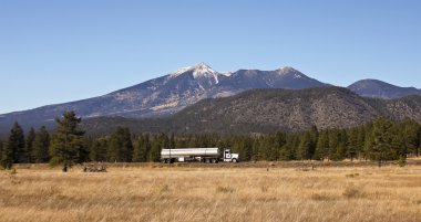 A Semi Tanker Truck at the Base of the San Francisco Peaks clipart