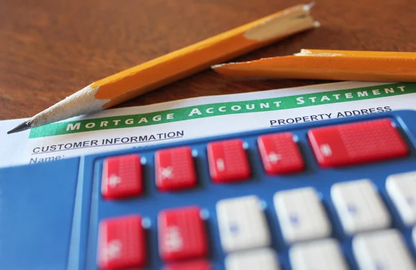 A Calculator, Broken Pencil, and Mortgage Statement