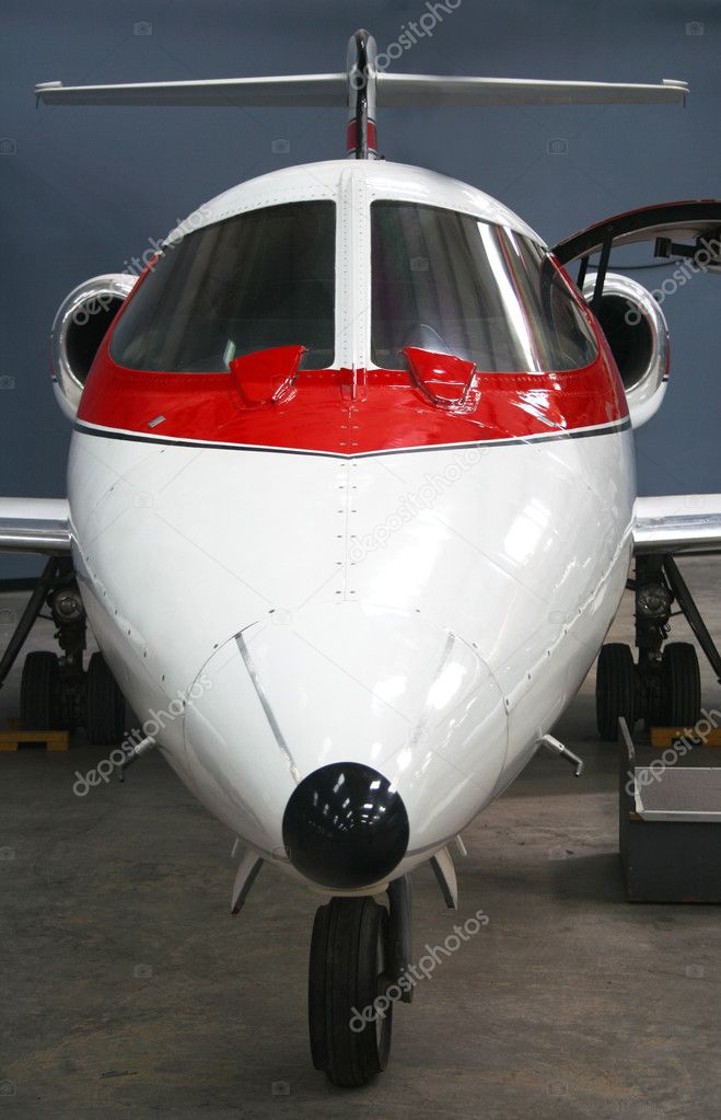 A Small Red and White Business Jet Aircraft