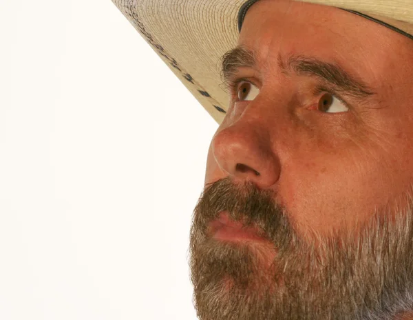 A Bearded Cowboy in a Straw Hat Looks Up — Stock Photo, Image
