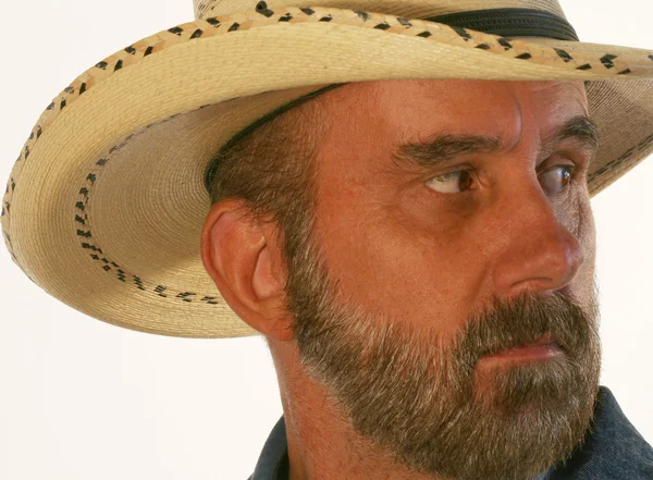 Un cowboy cu barbă se uită peste umărul său — Fotografie, imagine de stoc
