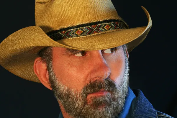 A Bearded Cowboy Glances Over His Shoulder — Stock Photo, Image