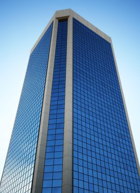 A Tall Glass Tower Reflects Sky Blue clipart