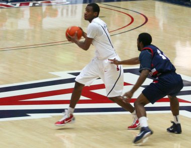 A Defender Chases Kevin Parrom in an Arizona Basketball Game clipart