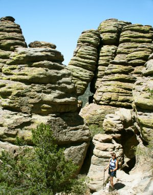 A Woman Dwarfed By 'Standing Up Rocks'