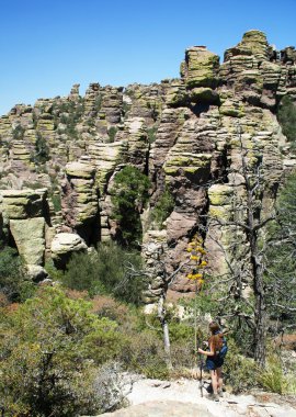 A Woman Dwarfed By 'Standing Up Rocks'