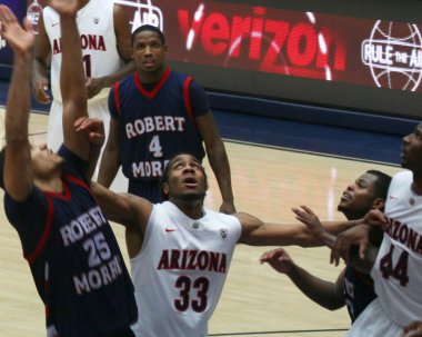 A Battle Under the Net in an Arizona Basketball Game clipart