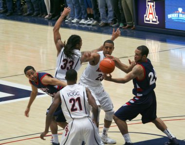 A Battle for the Ball in an Arizona Basketball Game clipart