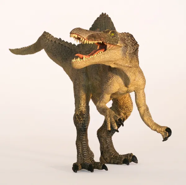 Un dinosaure spinosaure se tient sur un fond blanc — Photo