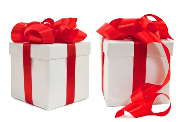Set of white boxes tied with a red satin ribbon bow. — Stock Photo, Image