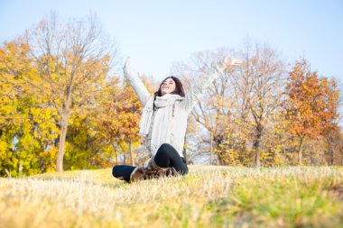 Beautiful woman enjoying in the park clipart