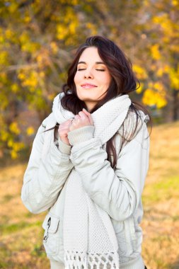 Beautiful woman enjoying in the autumn park clipart