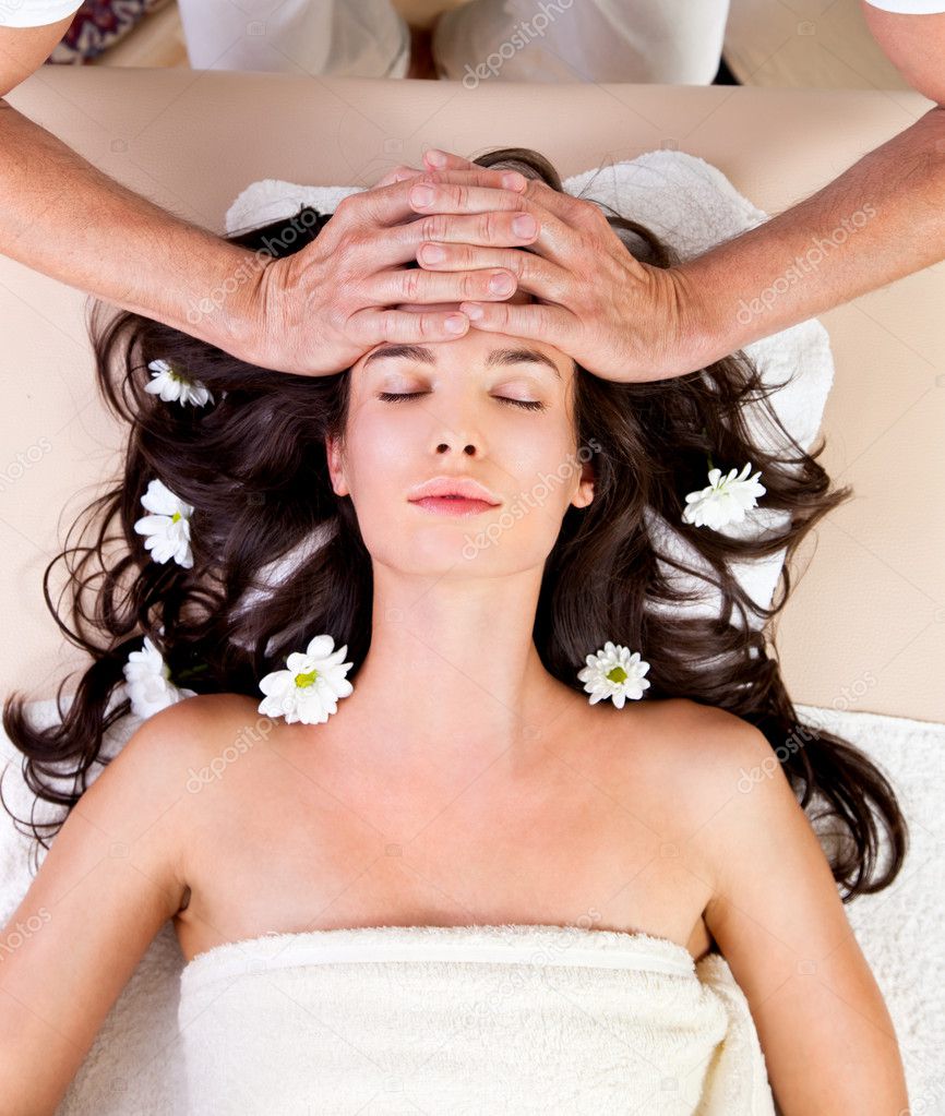 Beautiful brunette woman taking head massage