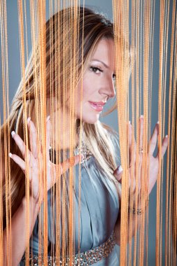 Woman peeking through the curtain clipart