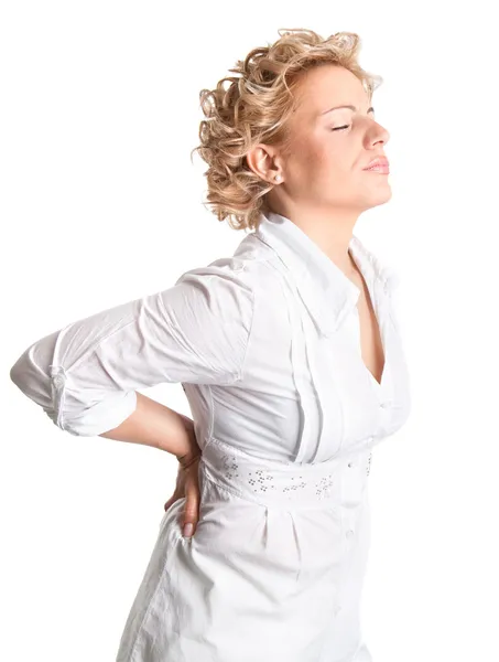 Mujer joven sostiene su espalda en el dolor . — Foto de Stock