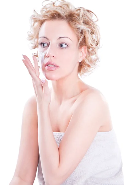 Beautiful young blond woman applying cream — Stock Photo, Image