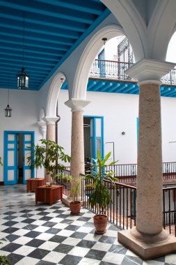 A view of colonial building interior with tropical flowers, Cuba clipart