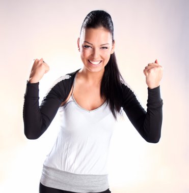 Champion woman standing with fists clenched in victory clipart