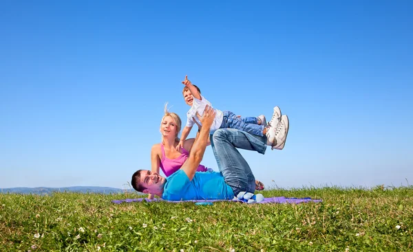 Happy family on picnic in park — Stock Photo, Image
