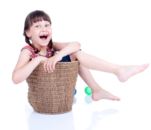 Cute girl sitting inside the basket — Stock Photo, Image