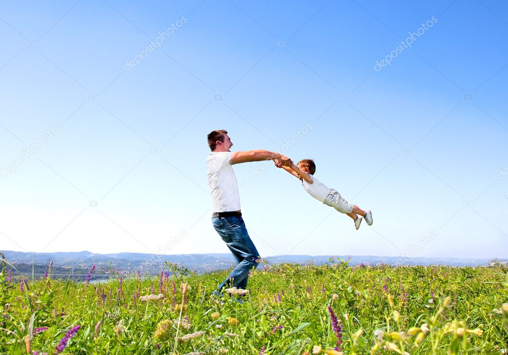 Father and son having fun in summer day