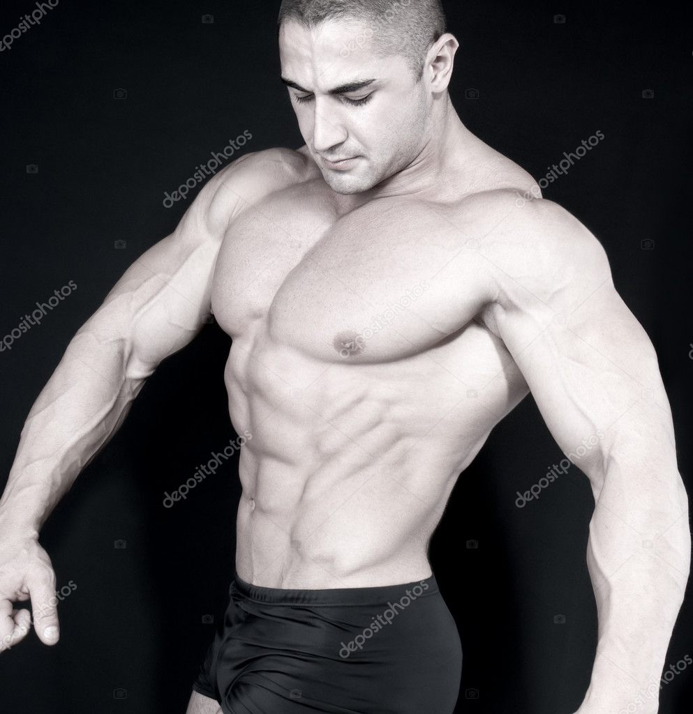 Athletic sexy attractive male body builder, demonstrating contest pose