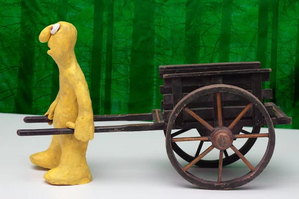 Hand cart and clay cartoon figurine — Stock Photo, Image