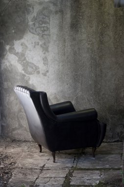 Black armchair and grey wall clipart