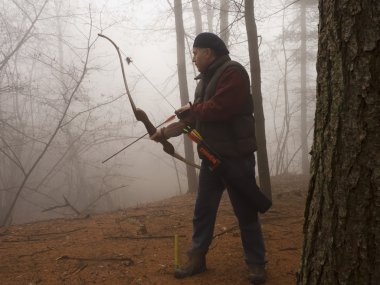 Archer preparing to shoot clipart