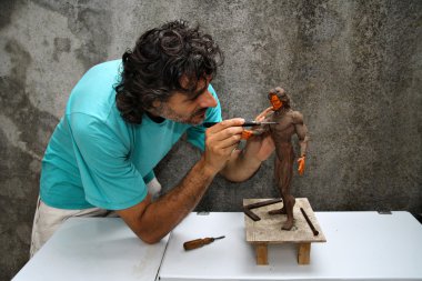 Artist working on a figurine clipart