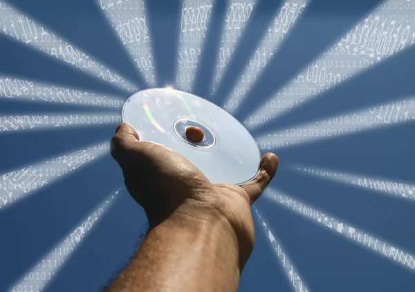 Ręka z cd i binarny kod promienie — Zdjęcie stockowe