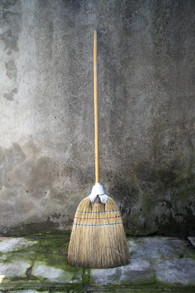 Broom over a grunge background — Stock Photo, Image