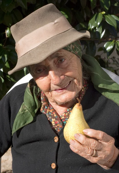 Senior woman with a pear — Stock Photo, Image