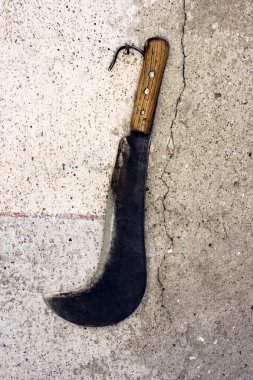 Sickle on a wall clipart