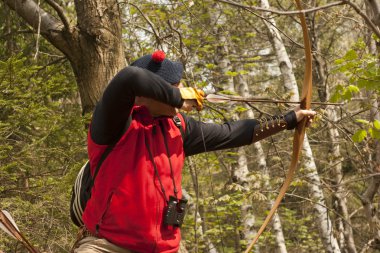 Man shooting with a long bow clipart