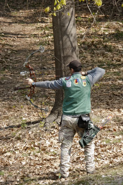 Man aiming with a technological bow — Stock Photo, Image