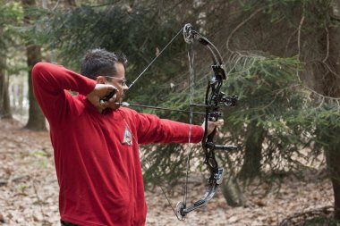 Man aiming with a technological bow clipart