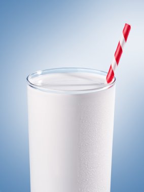 Glass of milk with striped red straw clipart