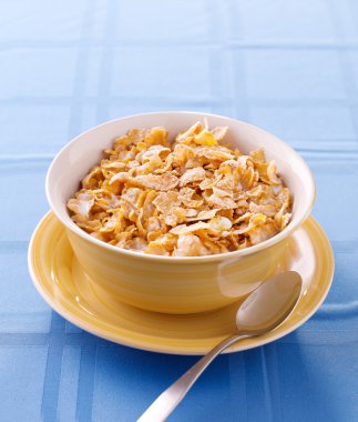 Bowl of crunchy corn flakes for breakfast with copyspace clipart