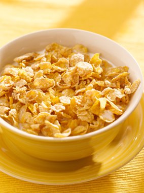 Bowl of crunchy corn flakes for breakfast clipart