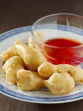 Sweet and sour chicken with dipping sauce. clipart