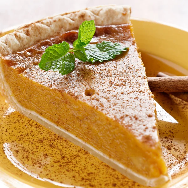 Pumpkin pie with mint garnish. — Stock Photo, Image