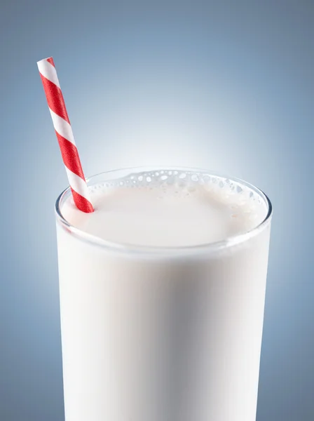 stock image Glass of milk with striped red straw