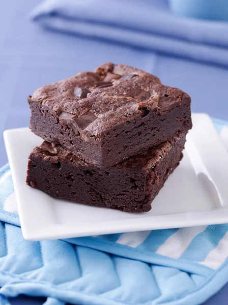 Two brownies stacked on a plate. — Stock Photo, Image