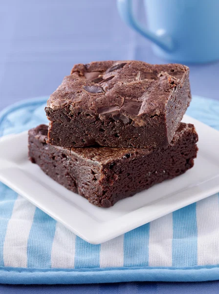 stock image Two brownies stacked on a plate.