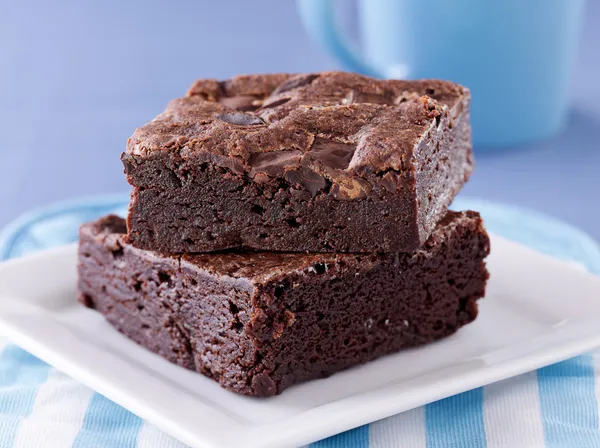 Two brownies stacked on a plate. — Stock Photo, Image