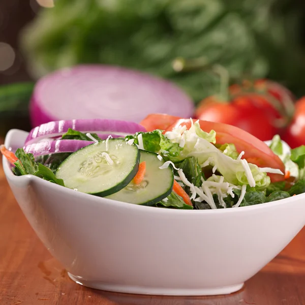 Salad bowl with cucumber onion and tomato with cheese — Stock Photo, Image